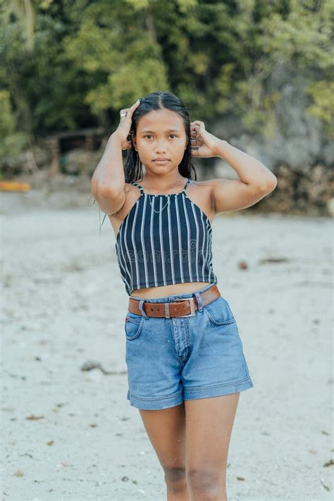 Portrait Of A Beauitful Brown Skin Filipina Model On A White Sand Beach In The Philippines Stock