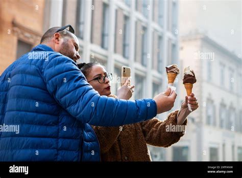 Influencers Photographing Ice Cream Cones For Social Media Post Stock