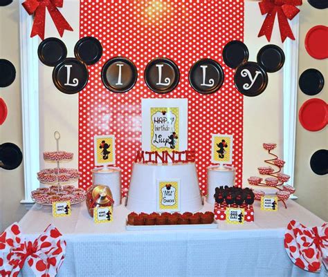 A Mickey Mouse Themed Birthday Party With Red And Black Decorations On The Wall Dessert Table