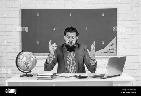 Mature Bearded Man Teacher In Costume Sit In School Classroom With Geography Globe Map