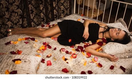 Attractive Brunette Lying On Bed Boudoir Stock Photo