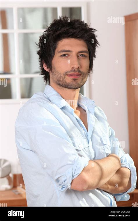 Man At Home In Kitchen Stood With Arms Folded Stock Photo Alamy