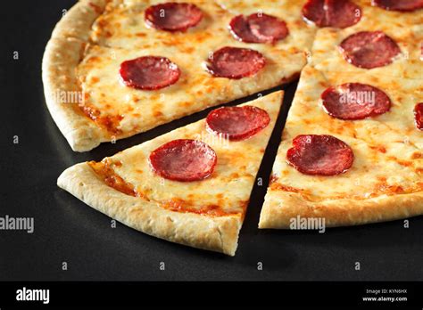 Cut Pizza Close Up Peperoni On Black Stone Background Stock Photo Alamy