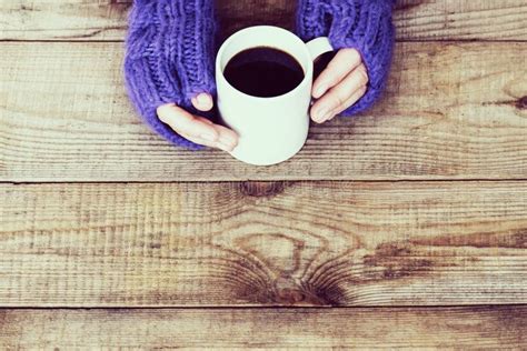 Woman Hands In Light Teal Knitted Mittens Are Holding Modern Tab Stock