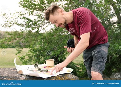 Man With Camera Exploring Map Outdoors Stock Photo Image Of Camp