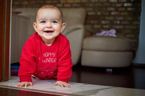 Premium Photo Cute Baby Girl Kneeling At Doorway