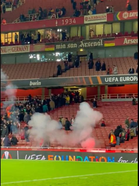 Chaos at end of Arsenal clash with PSV as away fans throw flares into ...