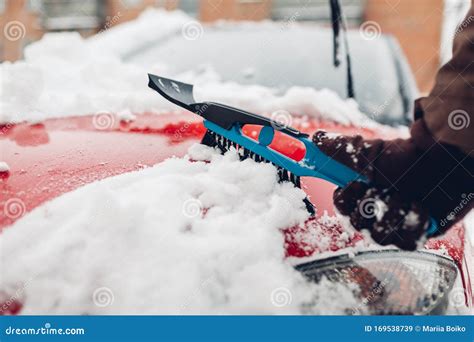 Car Cleaning From Snow Using Broom Man Taking Care Of Automobile