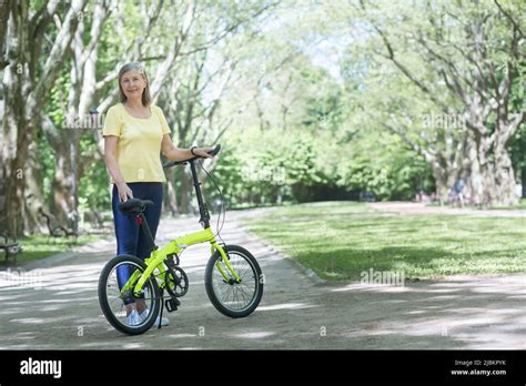 Attractive Mature Woman Riding Bike Hi Res Stock Photography And Images