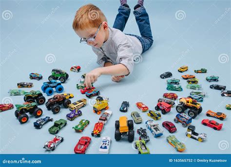 Niño Feliz Jugando En El Suelo Con Autos Modelo De Juguete A Su