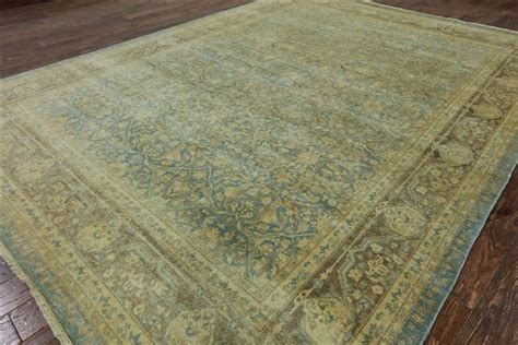 an antique rug is on the floor in a room with wood floors and hardwood ...