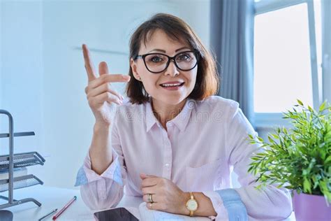 Webcam View Of Talking Mature Woman Sitting At Desk In Home Office Stock Image Image Of Call