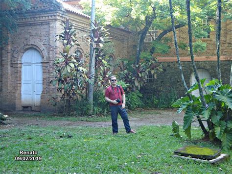 A Man Standing In The Middle Of A Yard With A Frisbee On His Hand