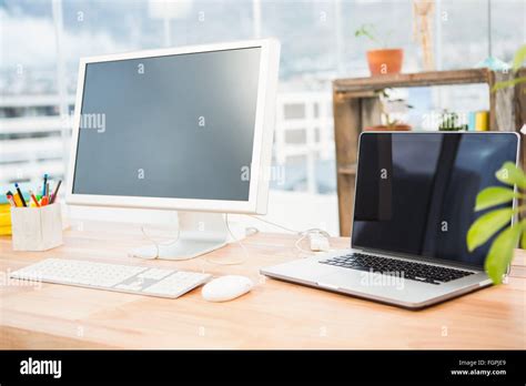 Working desk with computer and laptop Stock Photo - Alamy