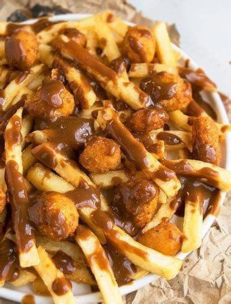 Quick and easy poutine recipe, loaded with french fries, cheese curds and topped off with brown ...