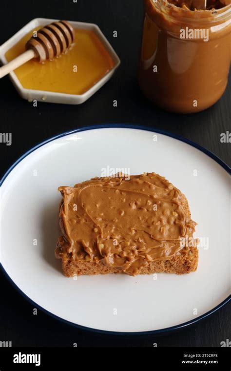 Peanut butter sandwich and honey Stock Photo - Alamy