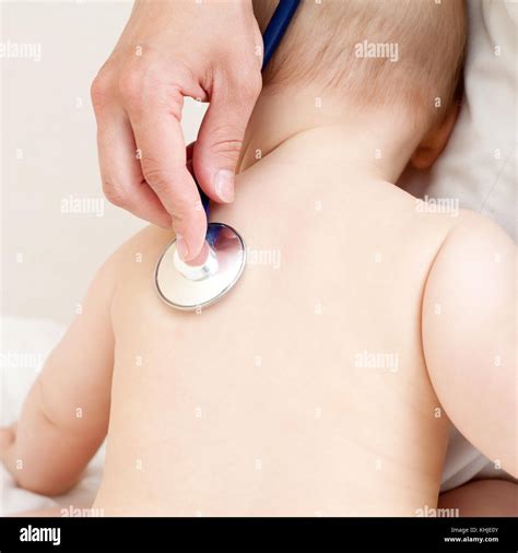 Pediatrician Examines Baby Girl Doctor Using A Stethoscope To Listen