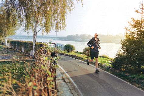 Man Jogging By The River Del Colaborador De Stocksy Lumina Stocksy