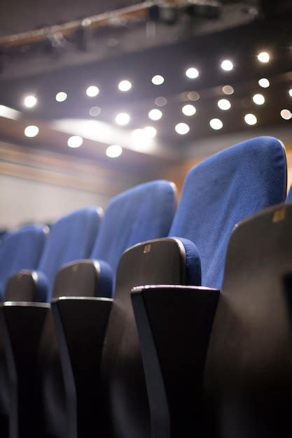 Premium Photo Low Angle View Of Empty Chairs In Auditorium