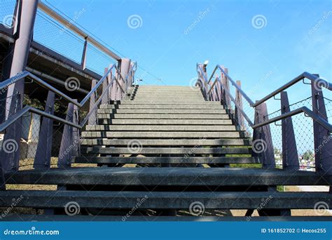 Outdoor Wide Concrete Stairs Surrounded With Inox Handrails And Wire