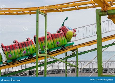 A Child`s Caterpillar Roller Coaster At A Funfair Editorial Stock Image