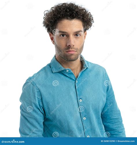 Portrait Of Casual Turkish Man With Curly Hair Wearing Blue Denim Shirt