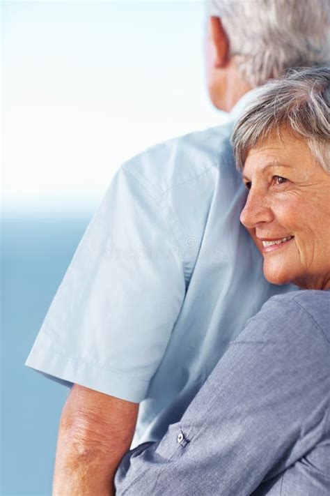 Love During Golden Years Smiling Mature Woman Hugging Man From Behind