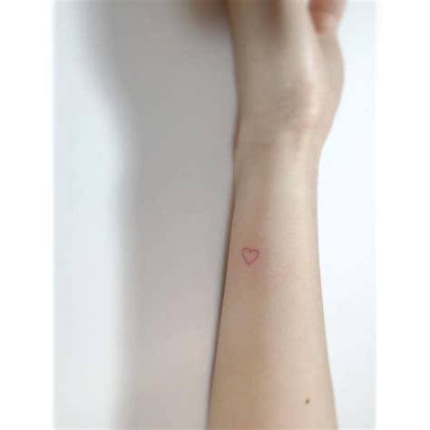 Tiny Minimalistic Red Heart Tattoo Located On The