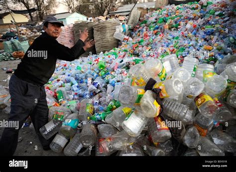 Chinese Man Collects Plastics Bottles At A Recycling Station In