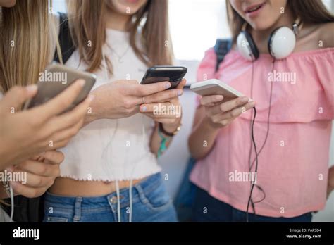 Teenage Girls Using Cell Phones In School Stock Photo Alamy