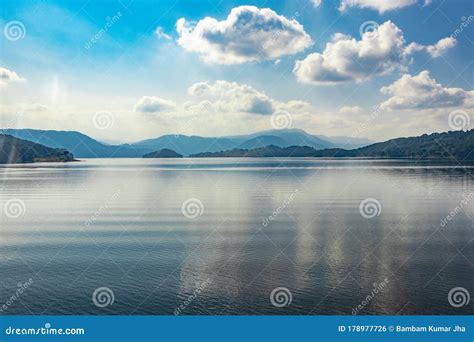 Lake Serene Blue Water With Misty Mountains And Clouds Reflections