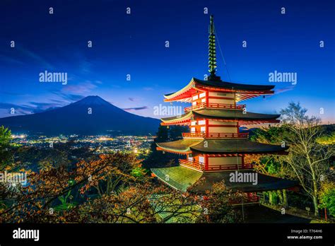 Mt Fuji With Chureito Pagoda And Red Leaf In The Autumn On Sunset At