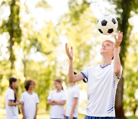 Ni O Jugando Con Una Pelota De F Tbol Fuera Foto Gratis