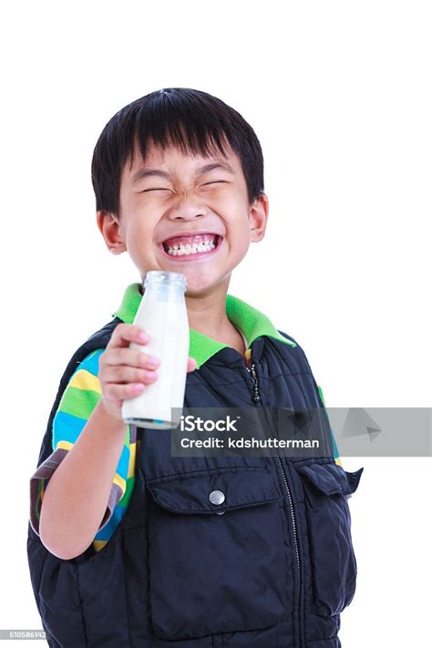 Closeup Boy Smiling And Holding Bottle Of Milk On White Stock Photo