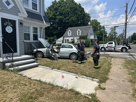 Car collision injuries three and damages a house in Hamden