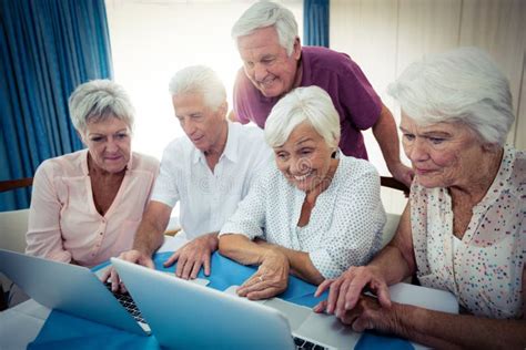 Group Of Seniors Using A Computer Stock Image Image Of Aged Helping