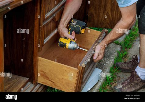 The Installing A Furniture Handle Process Of Assembling Kitchen Cabinet