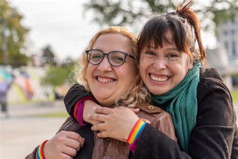 Portrait Of A Smiling Lesbian Couple Hugging Each Other While Standing