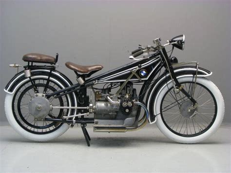 An Old Model Motorcycle Is Shown On A White Surface