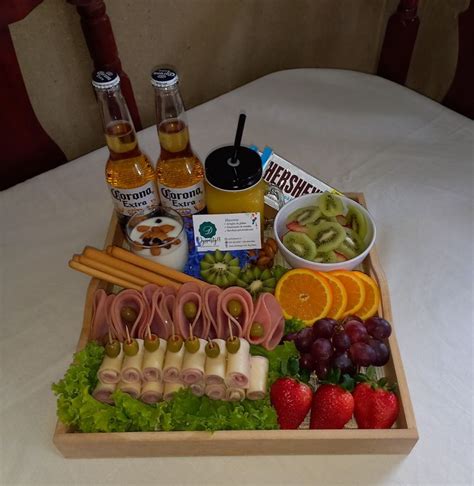 A Wooden Tray Filled With Assorted Foods And Condiments On Top Of A