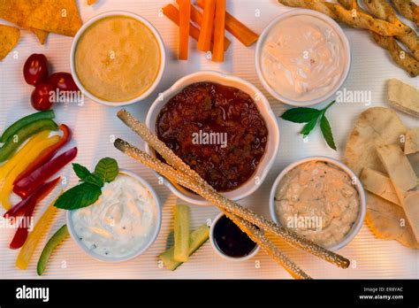 A Selection Of Party Dips With Bread Sticks Pita Bread And Other