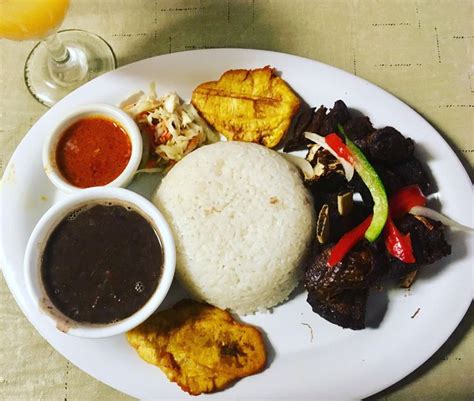 Taso Kabrit Fried Goat Served With Fried Plantain Spicy Haitian Slaw Rice And Beans I Ate