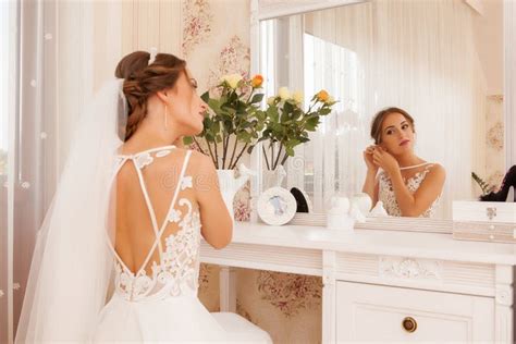 Lovely Bride Model Preparing To Wedding Day In Front Of Mirror Stock