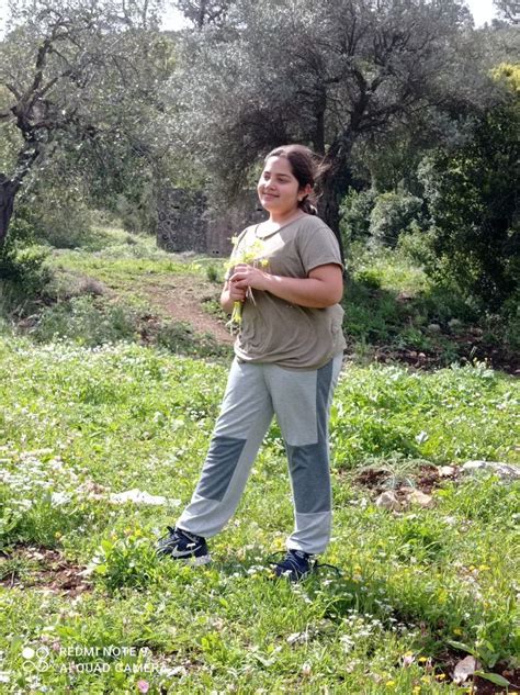 A Woman Standing In The Middle Of A Field