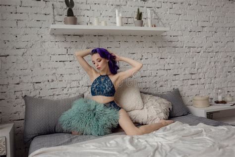 Charming Woman In Lingerie Lying On The Bed In The Room Stock Photo