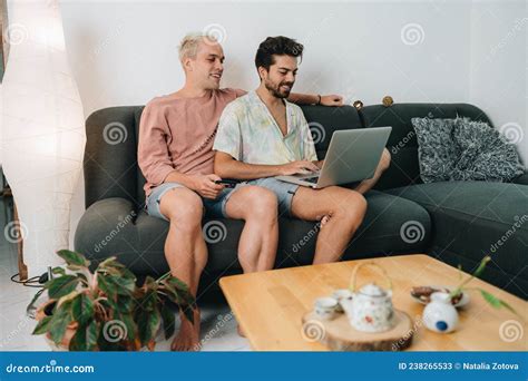 Gay Couple Sitting On Sofa With Laptop Stock Image Image Of Homosexual Together