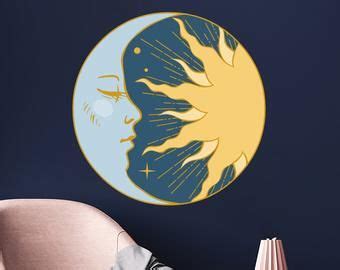 The Sun And Moon Wall Decals Are Shown In This Living Room With Blue Walls