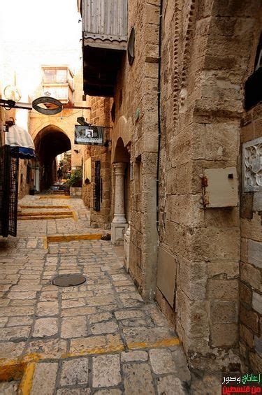 An Alley Way With Cobblestones And Stone Buildings