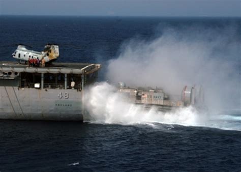 A Navy Landing Craft Air Cushion Enters The Well Deck Of The Amphibious