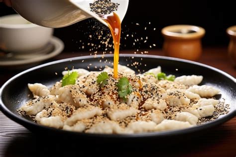 Premium Photo Sprinkling Sesame Seeds Over A Dish Of Dumplings